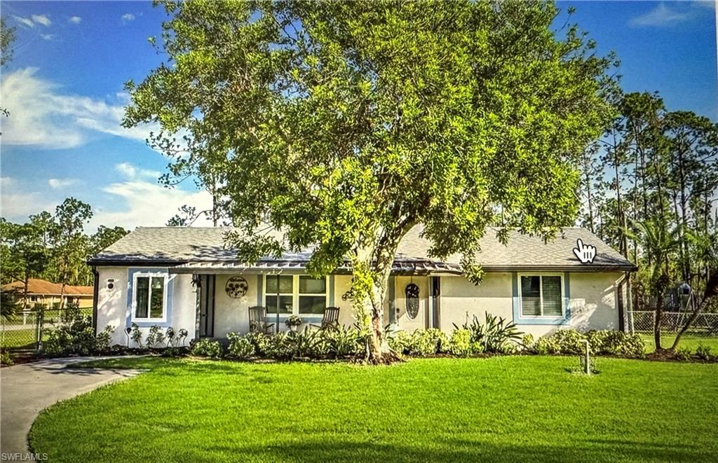 Ranch-style home with stucco siding and a shingled roof