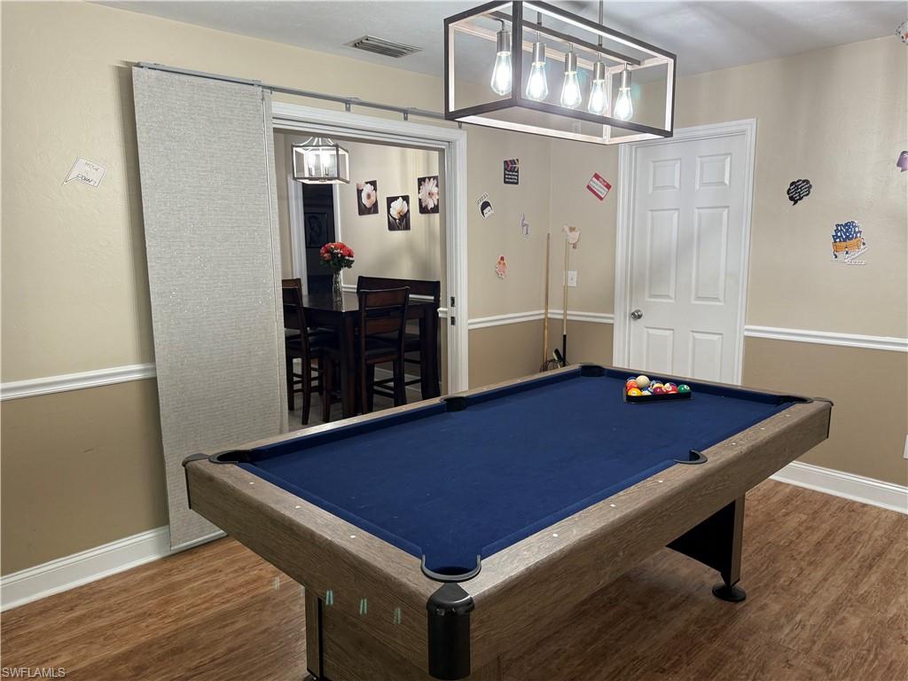Recreation room featuring pool table and wood finished floors
