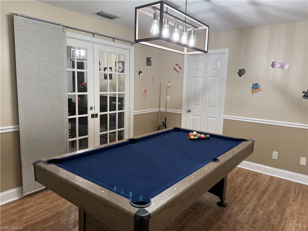 Recreation room with french doors, billiards, and wood finished floors