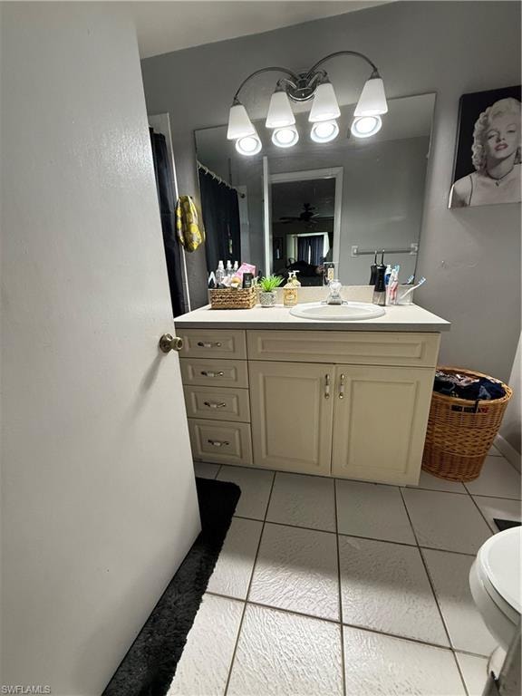 Full bathroom with vanity, curtained shower, and light tile patterned flooring