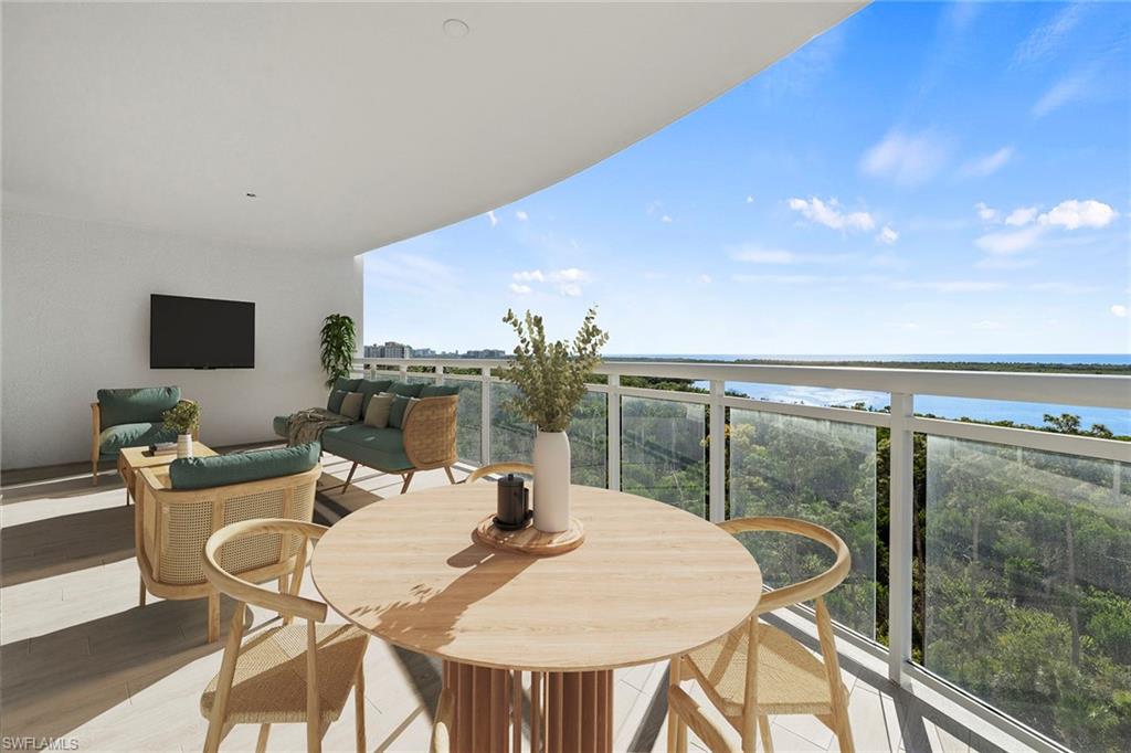 Balcony with outdoor dining area and a water view