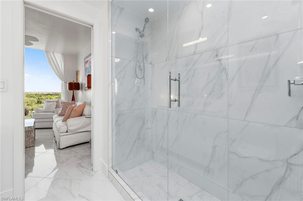 Ensuite bathroom with a marble finish shower