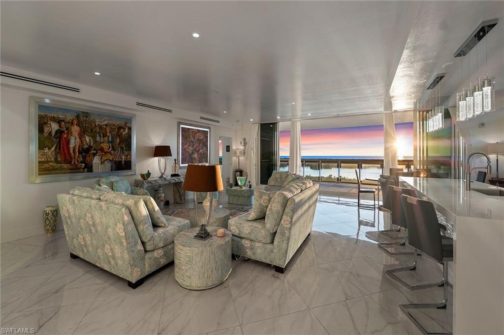 Living room with light marble finish flooring and recessed lighting