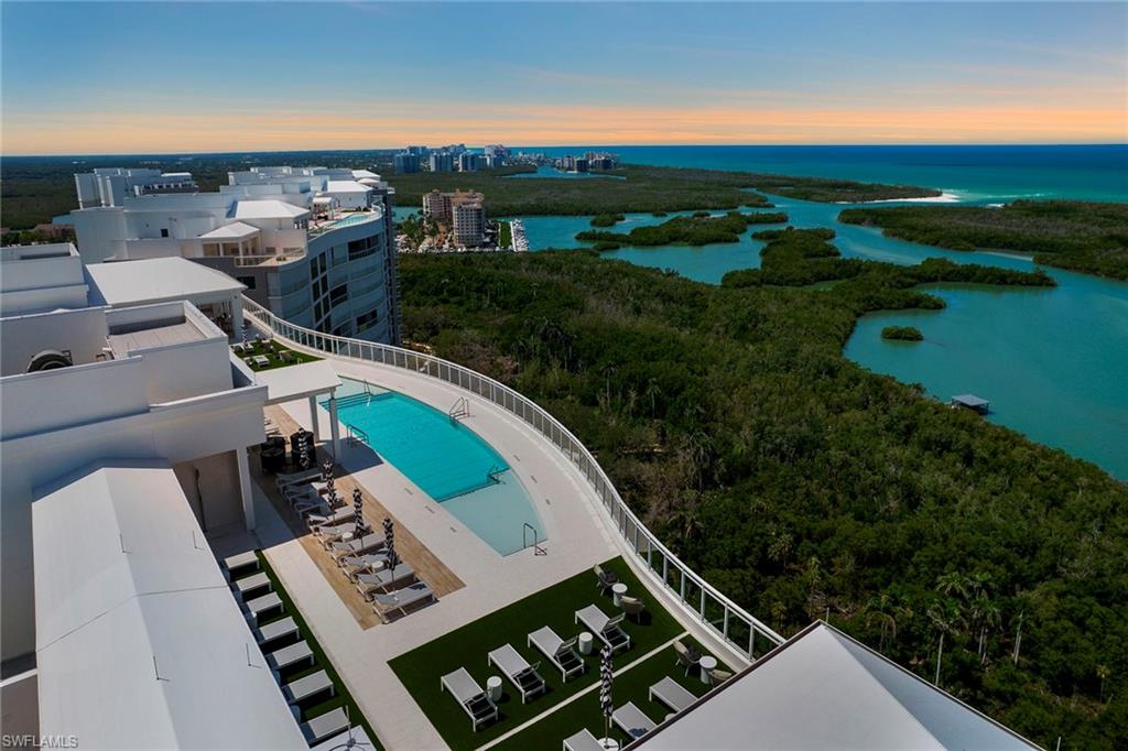 Bird's eye view of a pool area and a large body of water