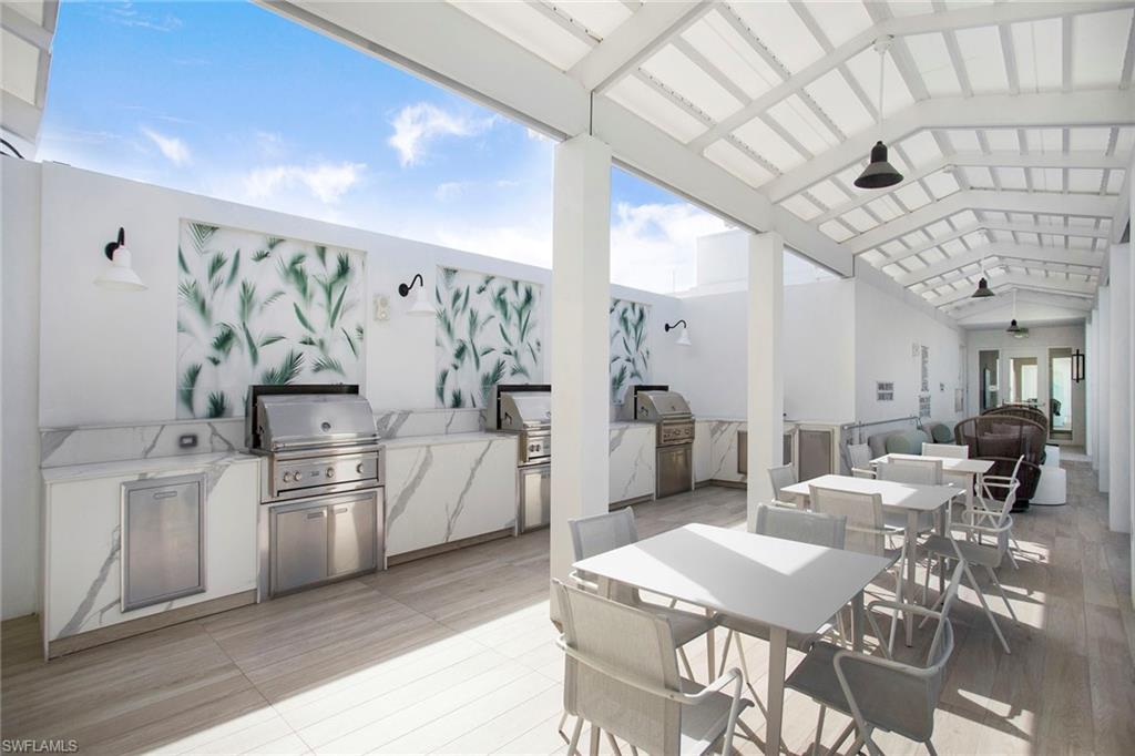 View of rooftop patio / terrace with area for grilling, and outdoor dining space.