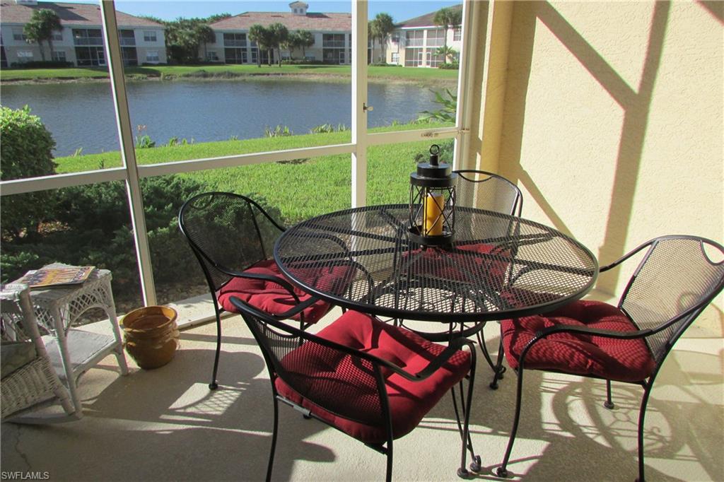 Sunroom with a water view and outdoor dining area