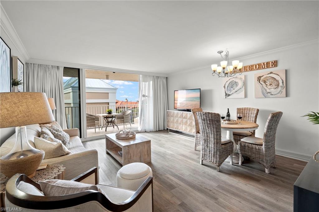 Spacious living room with sleeper sofa, sitting chair with ottoman, dining for 4, custom drapes