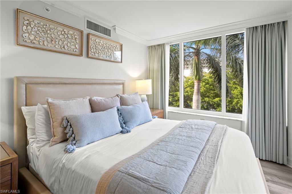 Bedroom featuring crown molding and wood finished floors