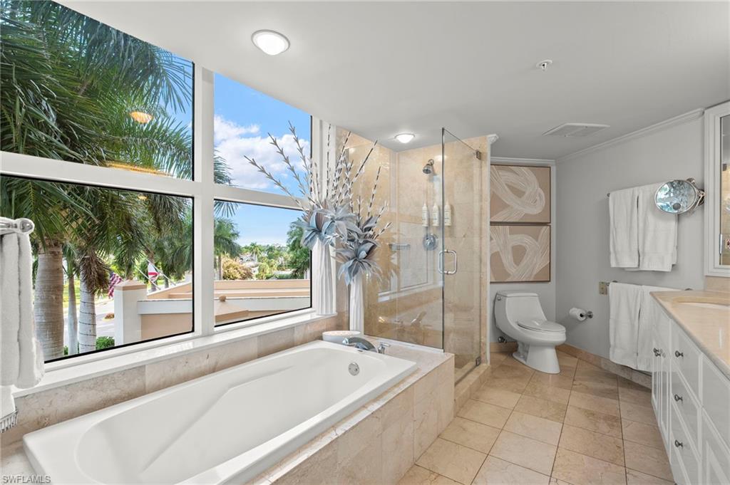 Primary ensuite bath with soaking tub, separate shower and oversized double bowl vanity.