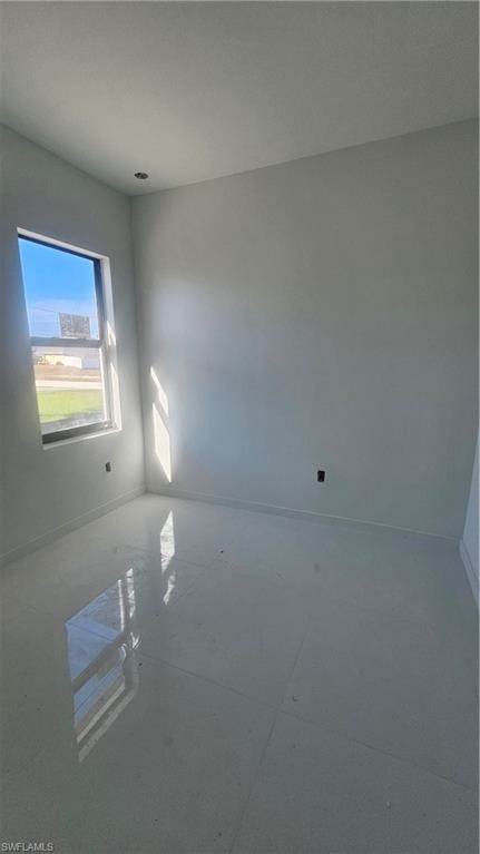 Unfurnished room with baseboards