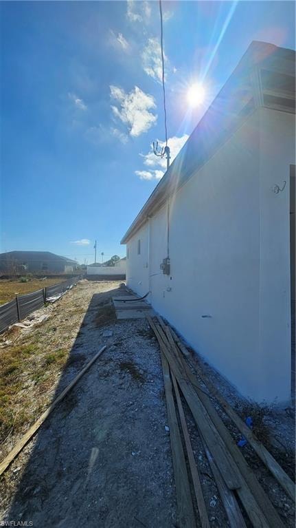 View of side of home featuring stucco siding