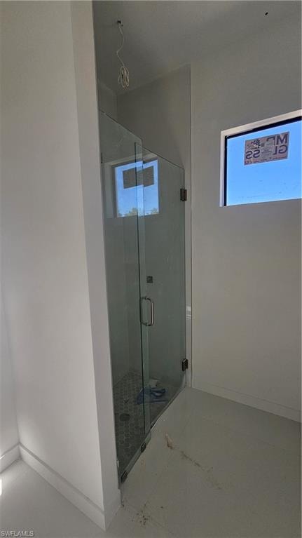 Full bathroom featuring baseboards and a stall shower