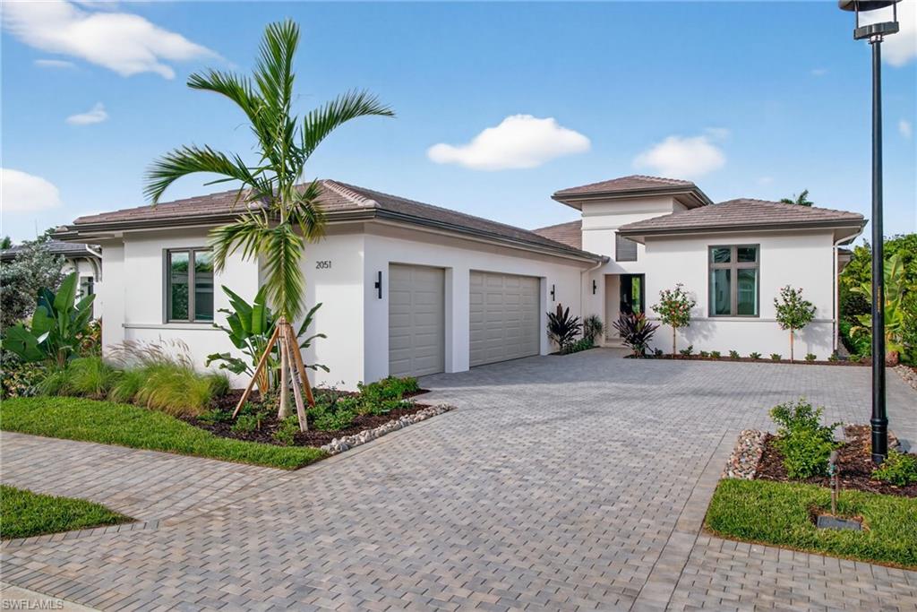 Front view of this boutique home located in the private gated community of Cambridge Park at Orange Blossom