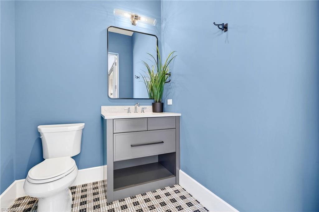 Pool bath featuring a simple vanity and a stylish tile patterned flooring