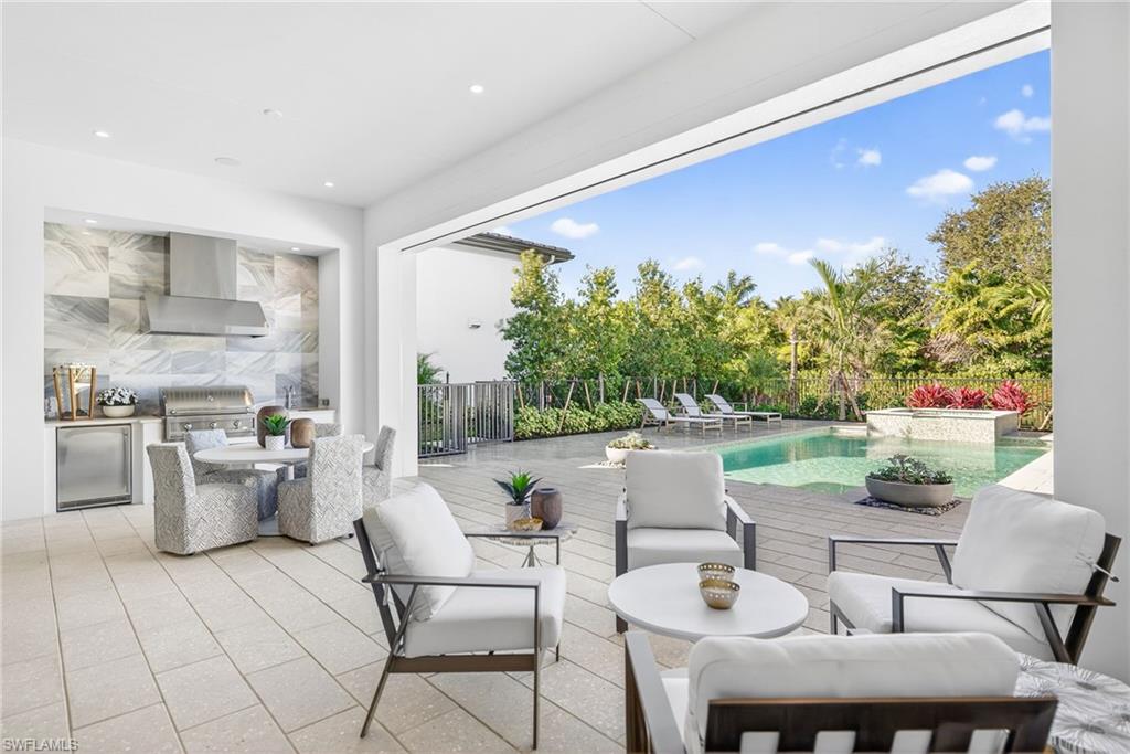 Spacious patio /terrace with outdoor kitchen area and dining area, plenty of  space for lounging around the pool and spa