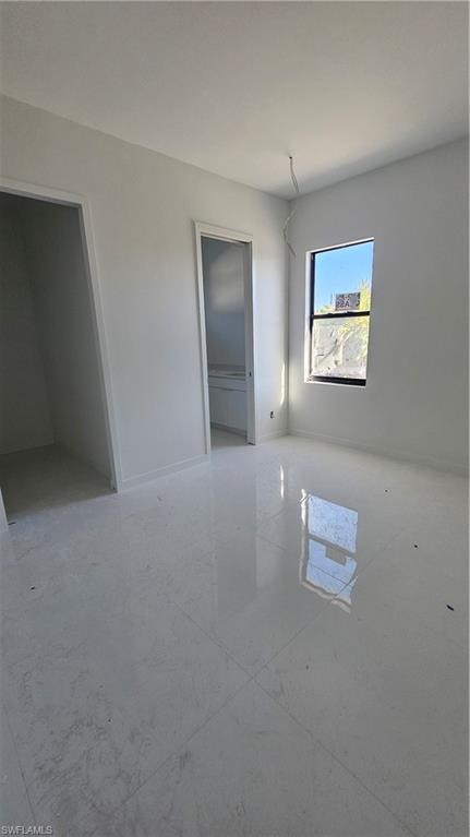 Spare room featuring baseboards