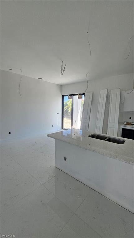 Unfurnished room featuring a sink