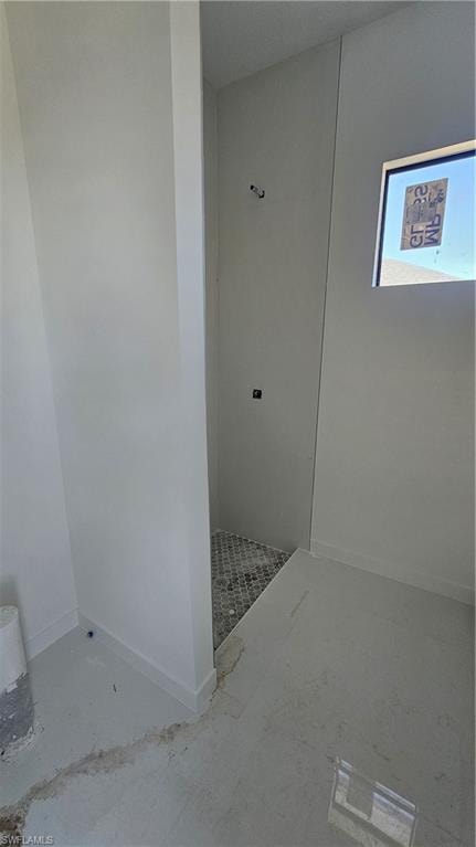 Full bath with walk in shower and baseboards