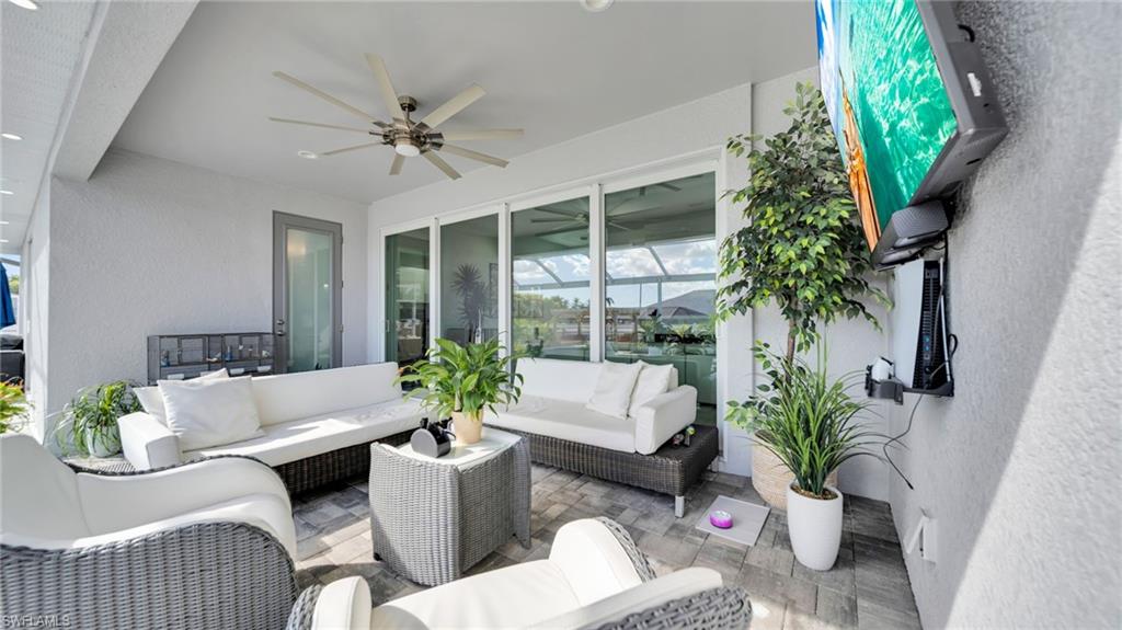 View of patio with a ceiling fan and an outdoor hangout area