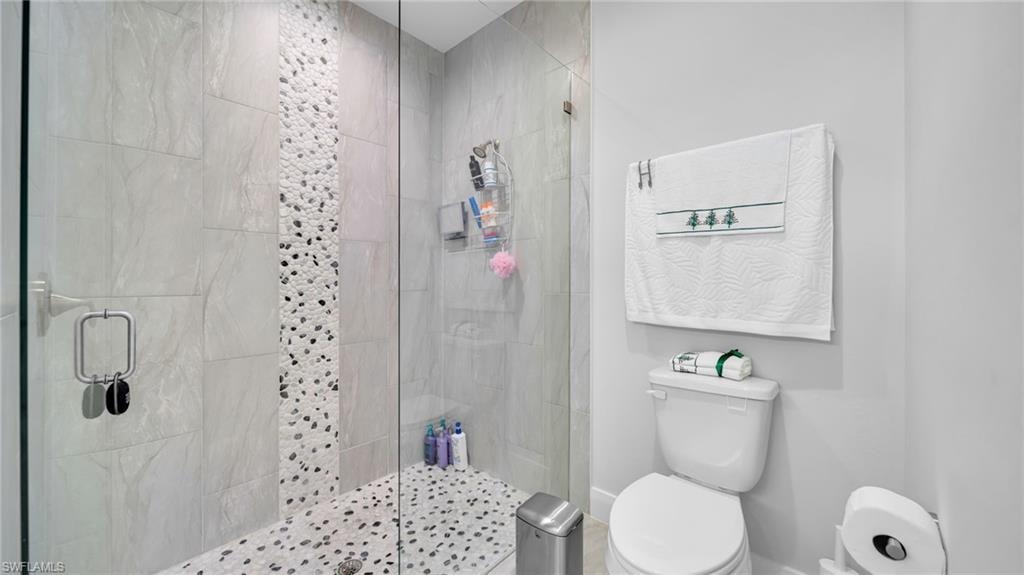 Full bathroom with a stall shower and toilet