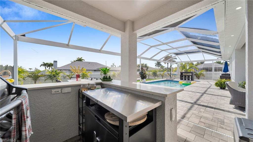 View of patio / terrace with a lanai, a sunroom, and an outdoor pool