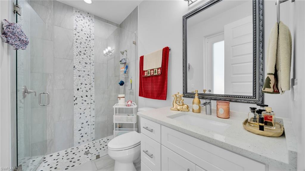 Full bath featuring a shower stall and vanity