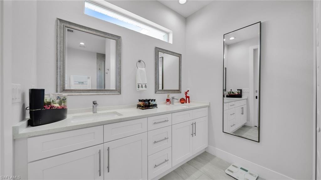 Bathroom with double vanity and recessed lighting