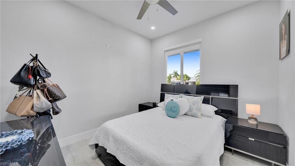 Bedroom with a ceiling fan, recessed lighting, and light marble finish floors