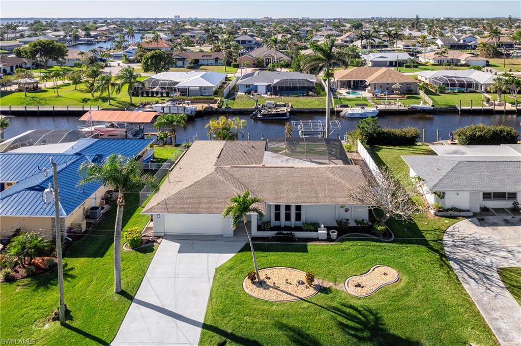 Aerial view of residential area featuring a large body of water
