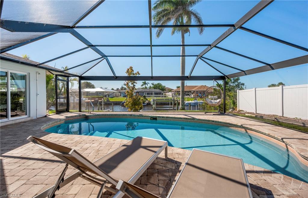 Outdoor pool featuring a water view, a lanai, a sunroom, a patio area, and boat lift