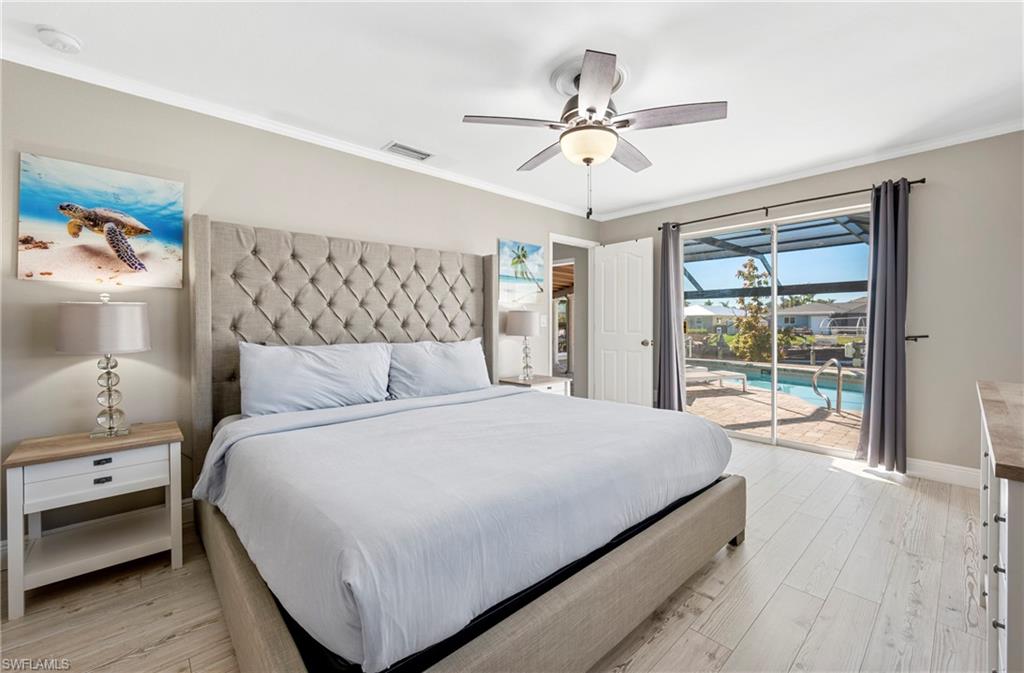 Bedroom featuring ornamental molding, light wood-style flooring, access to exterior, and ceiling fan
