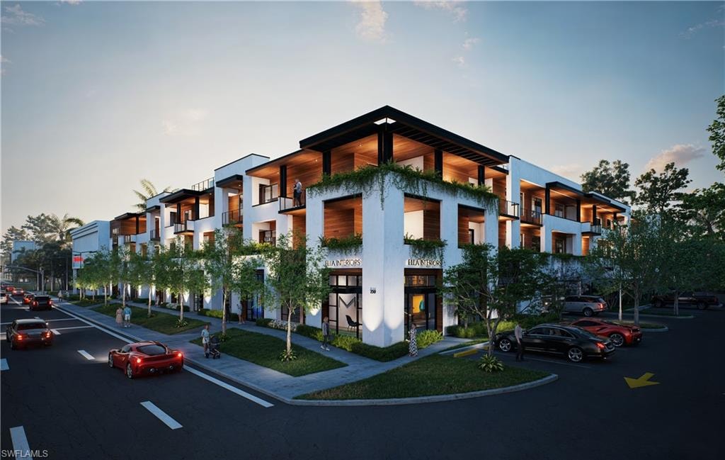 Property at dusk with a view of apartment building / complex