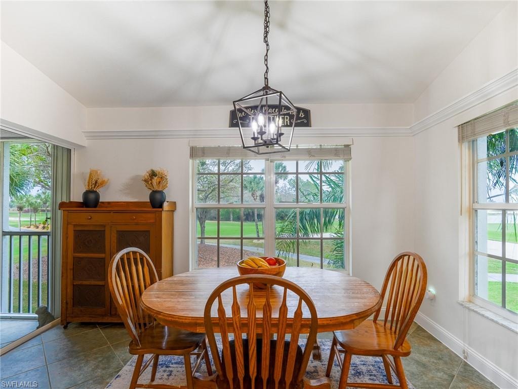 Dining space featuring hanging lights and baseboards