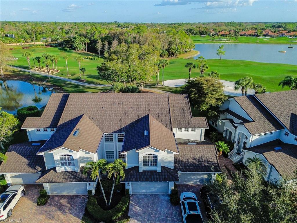 Aerial perspective of suburban area with a nearby body of water and a golf club