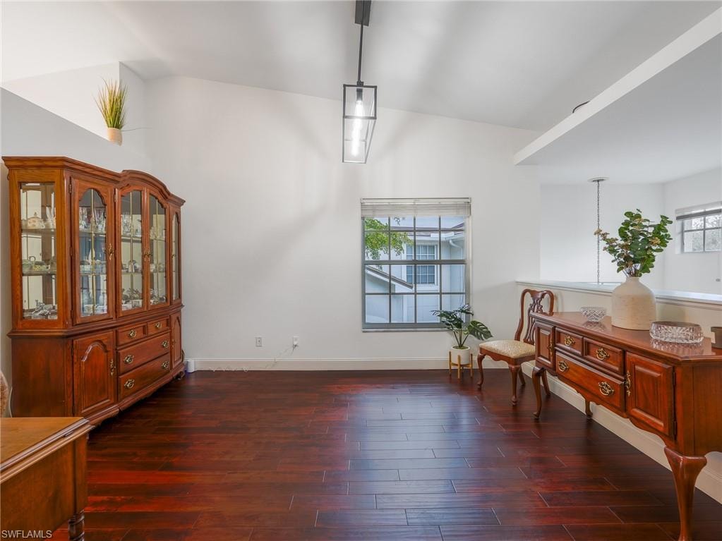 Den area featuring dark wood finished floors and plenty of natural light