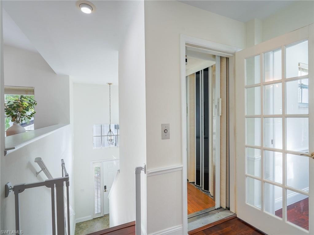 Hall featuring dark wood finished floors and elevator