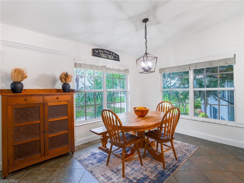 Dining room with vaulted ceiling and hanging lights