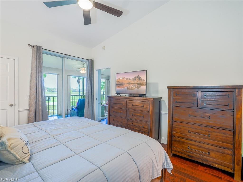 Bedroom featuring access to outside, dark wood-style flooring, a ceiling fan, and vaulted ceiling