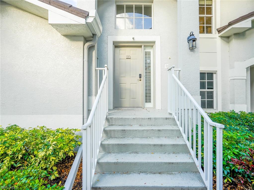 Entrance to property featuring stucco siding