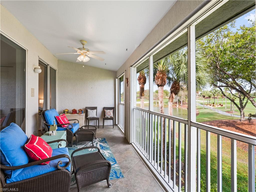 Sunroom / solarium with ceiling fan, a water view, golf course view, and a balcony