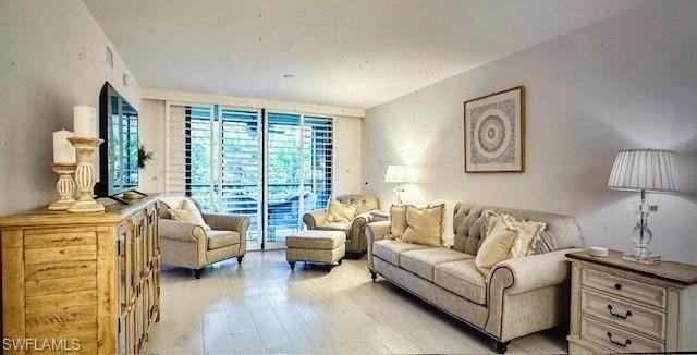 Living room featuring hardwood / wood-style flooring and expansive windows