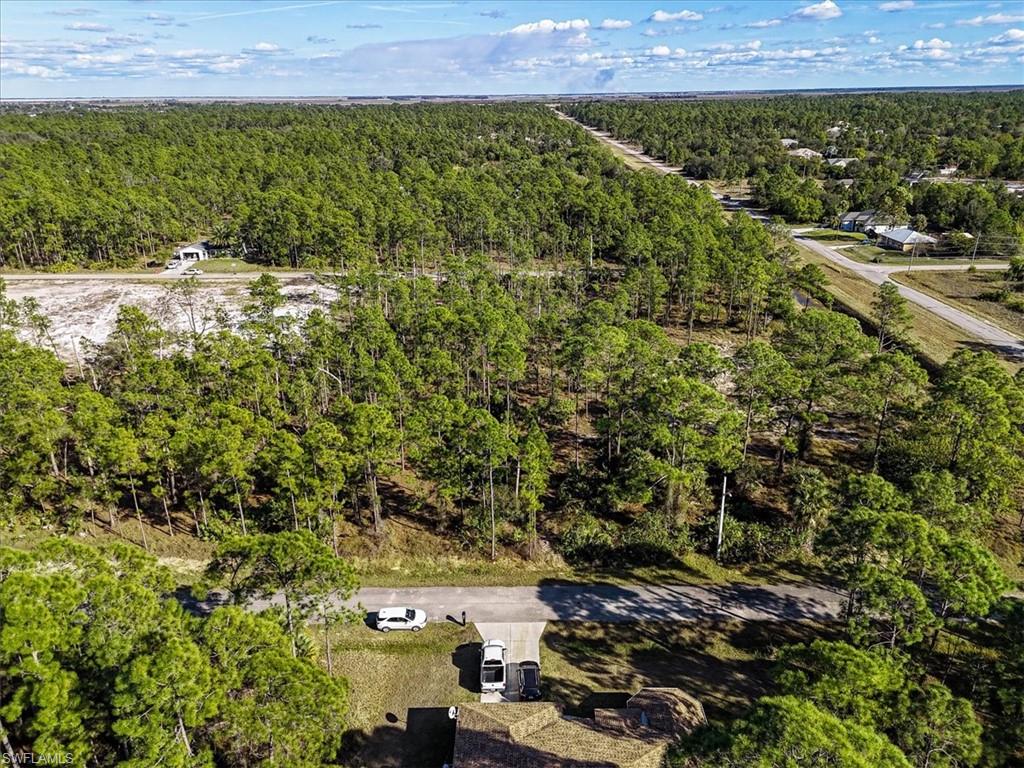 Aerial view of property's location with a forest