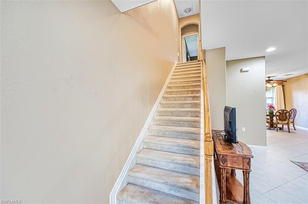 Staircase featuring tile patterned flooring, recessed lighting, and a ceiling fan