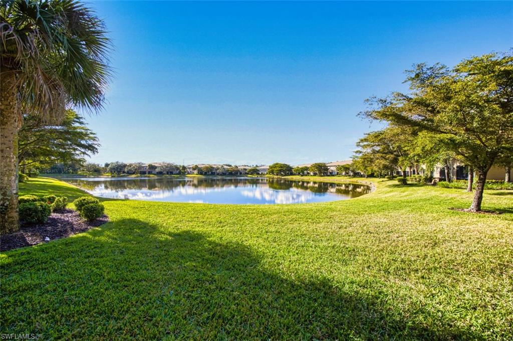View of grassy yard with a water view