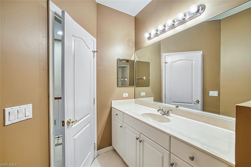 Bathroom with vanity and light tile patterned flooring
