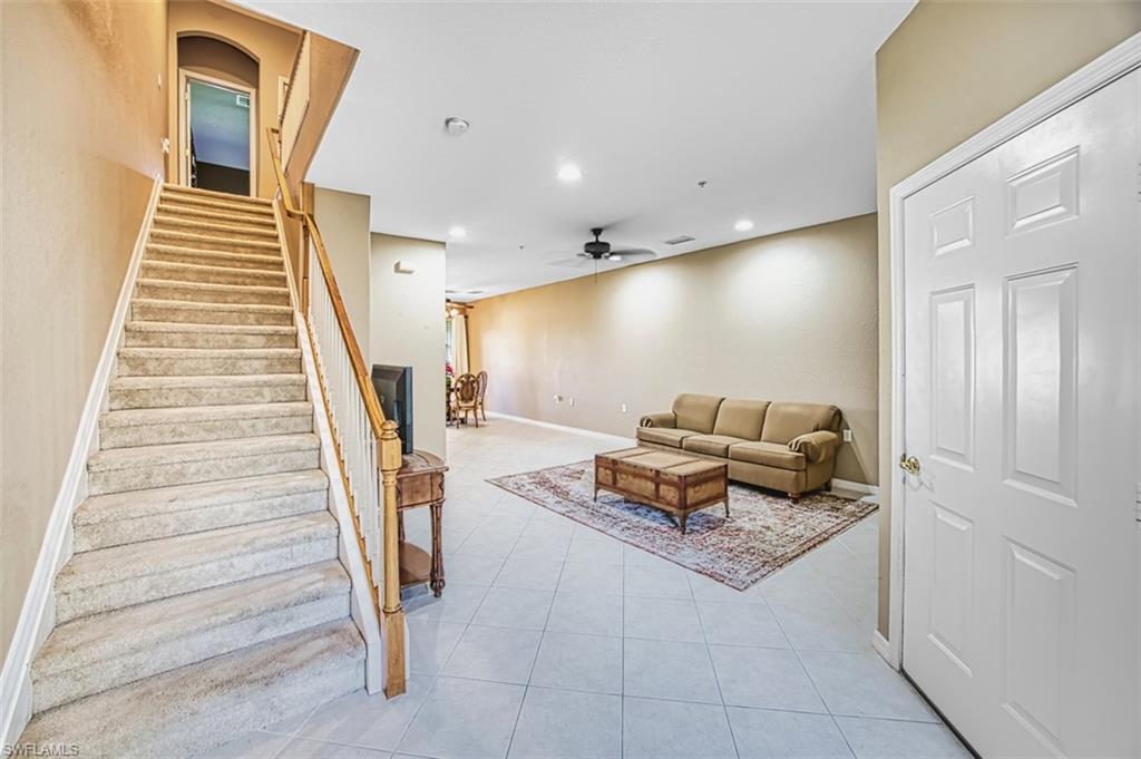 Stairway featuring recessed lighting, tile patterned floors, and ceiling fan