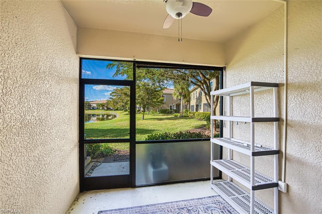 Unfurnished sunroom featuring ceiling fan and a water view