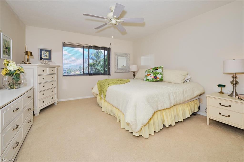 Bedroom featuring light colored carpet and ceiling fan
