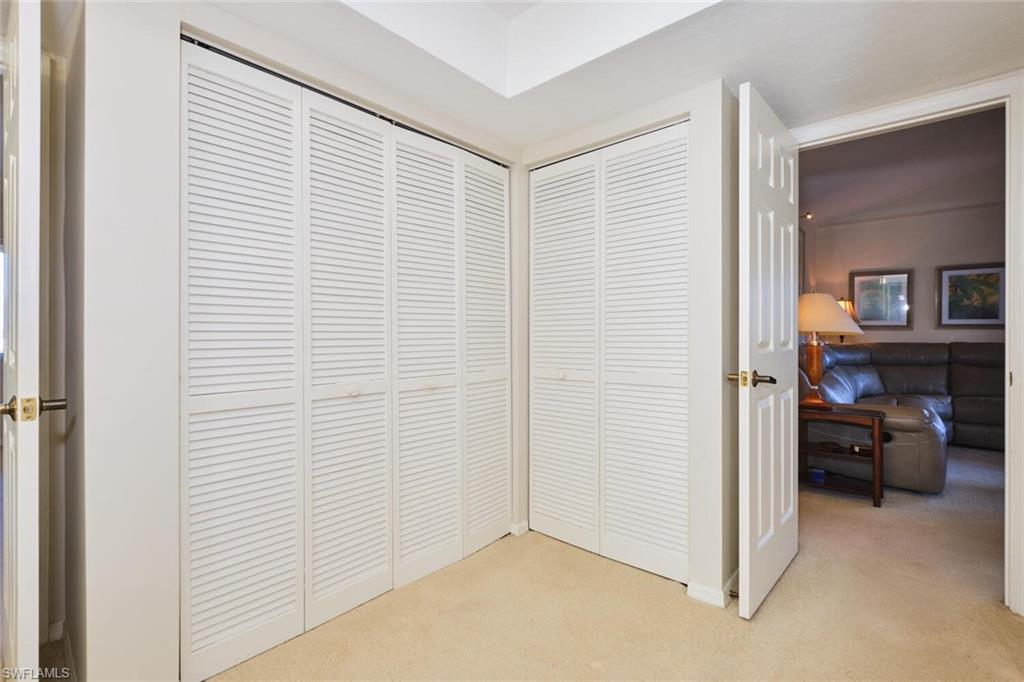Corridor featuring light carpet