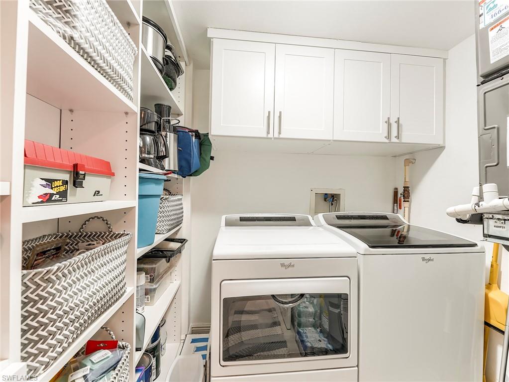 Washroom with cabinet space and washer and dryer